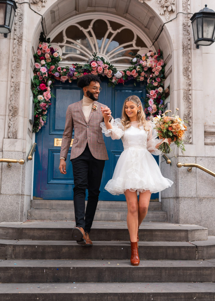 Couple walk down Chelsea town hall steps after their London wedding