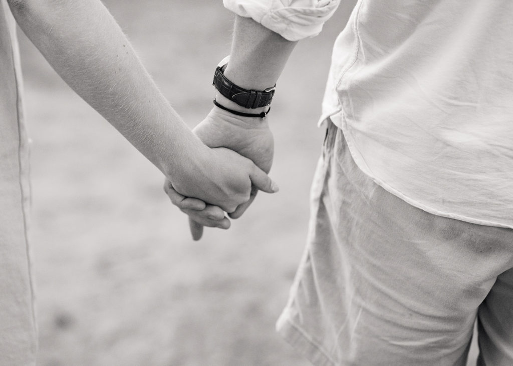 black and white portrait of couple holding hands 