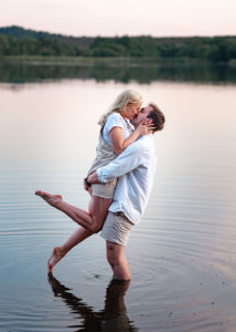 engaged couple, man picking up fiance kissing in river at pre-wedding photoshoot