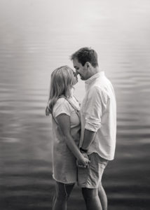 couple kissing in black and white in a lake at pre-wedding photoshoot