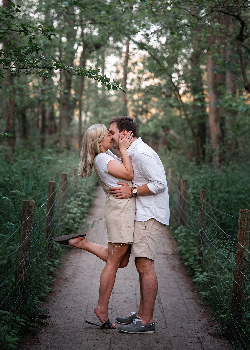 couple kiss on forest boardwalk