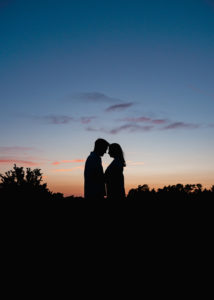 silhouetted couple with sunset sky