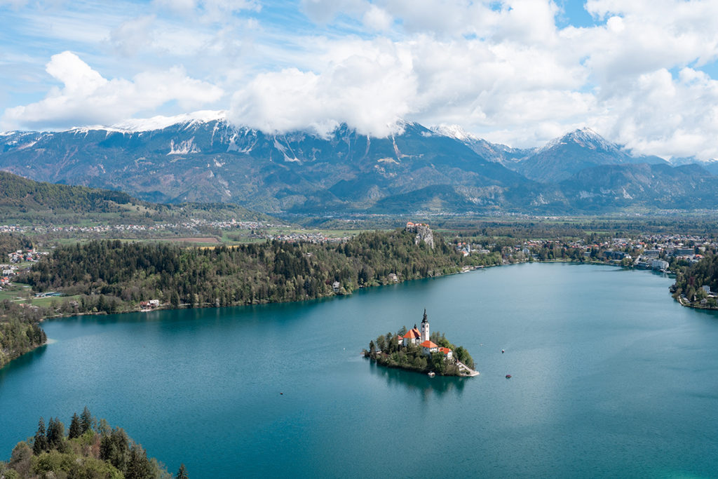 Photo of lake bled wedding island with mountains behind. Lake Bled church wedding in Slovenia