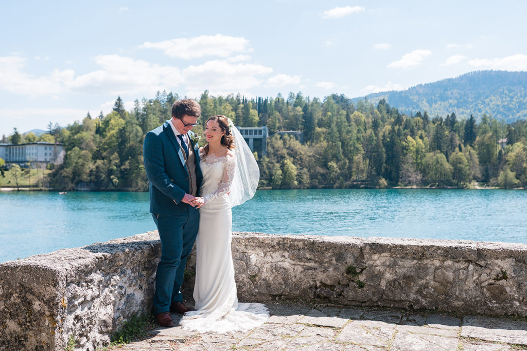 Bride and Groom stood overlooking lake bled on wedding day