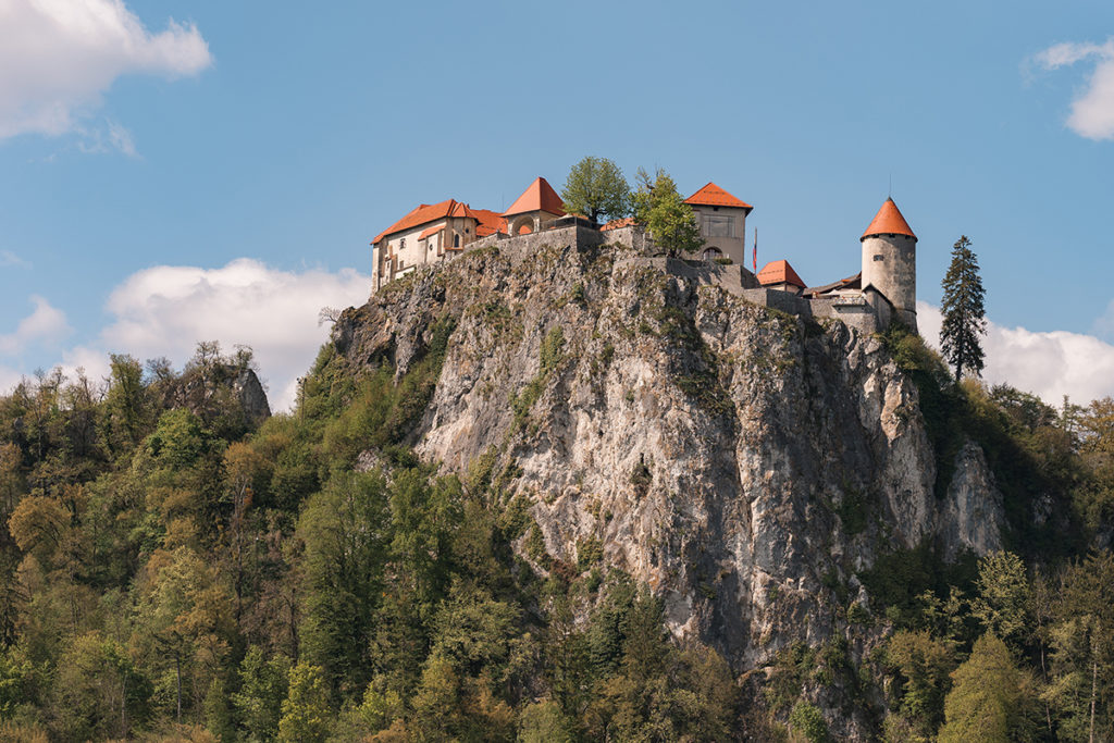 view of Lake Bled Castle on Wedding day from the lake