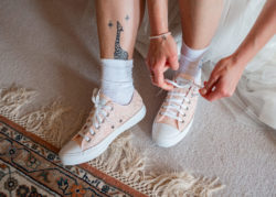 Bride putting on converse