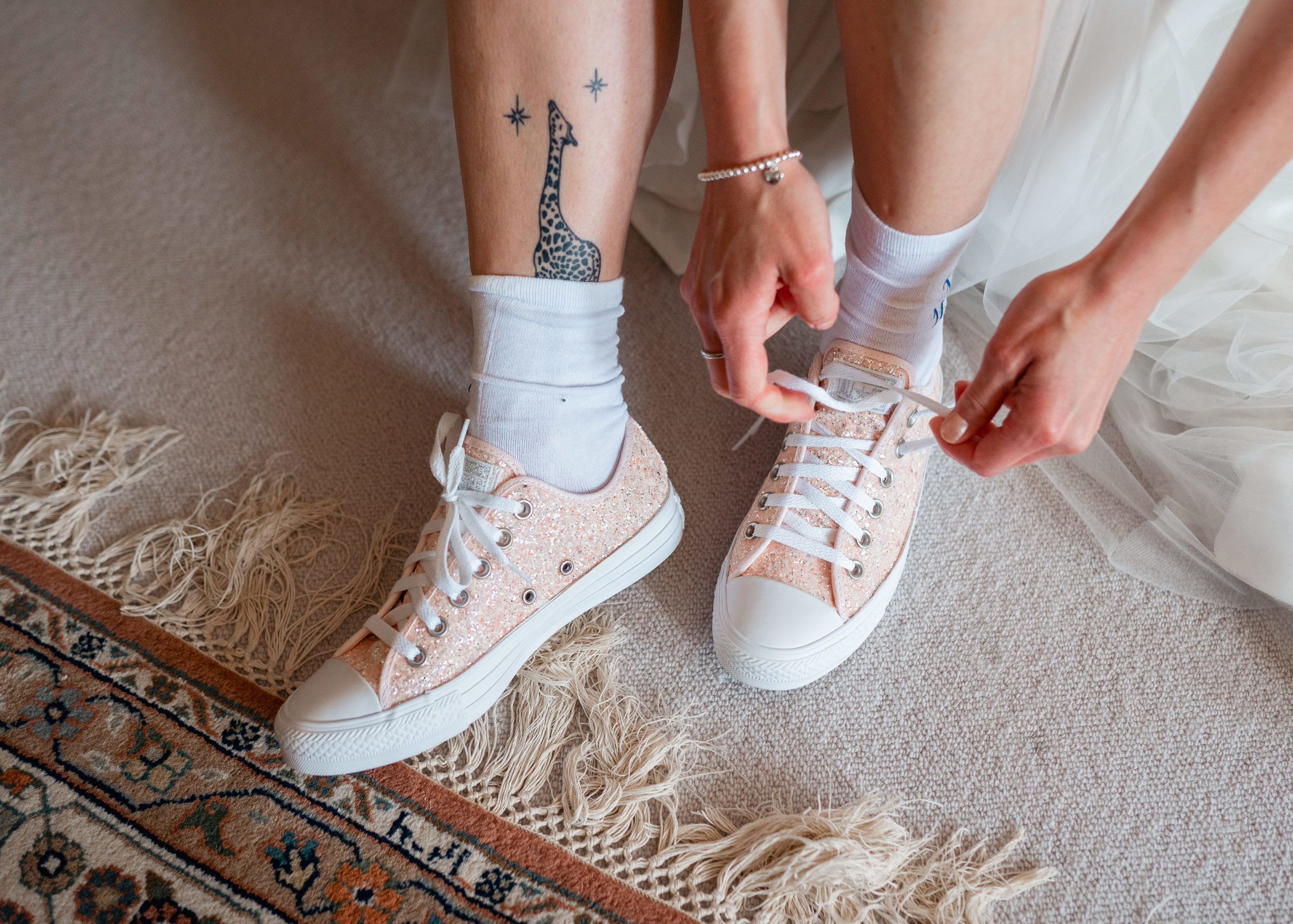 Bride putting on converse