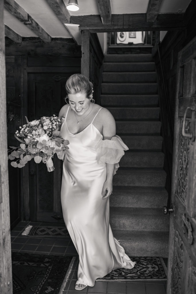 bride walking down stairs of intimate oxford wedding venue