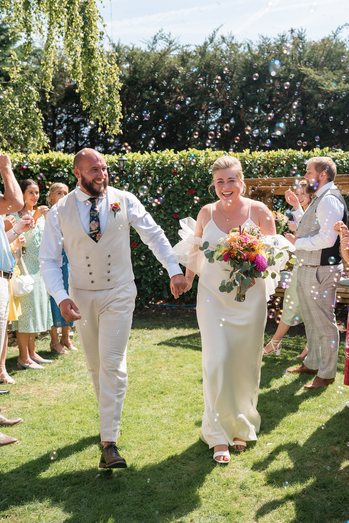 newlyweds walk through bubbles in intimate ceremony