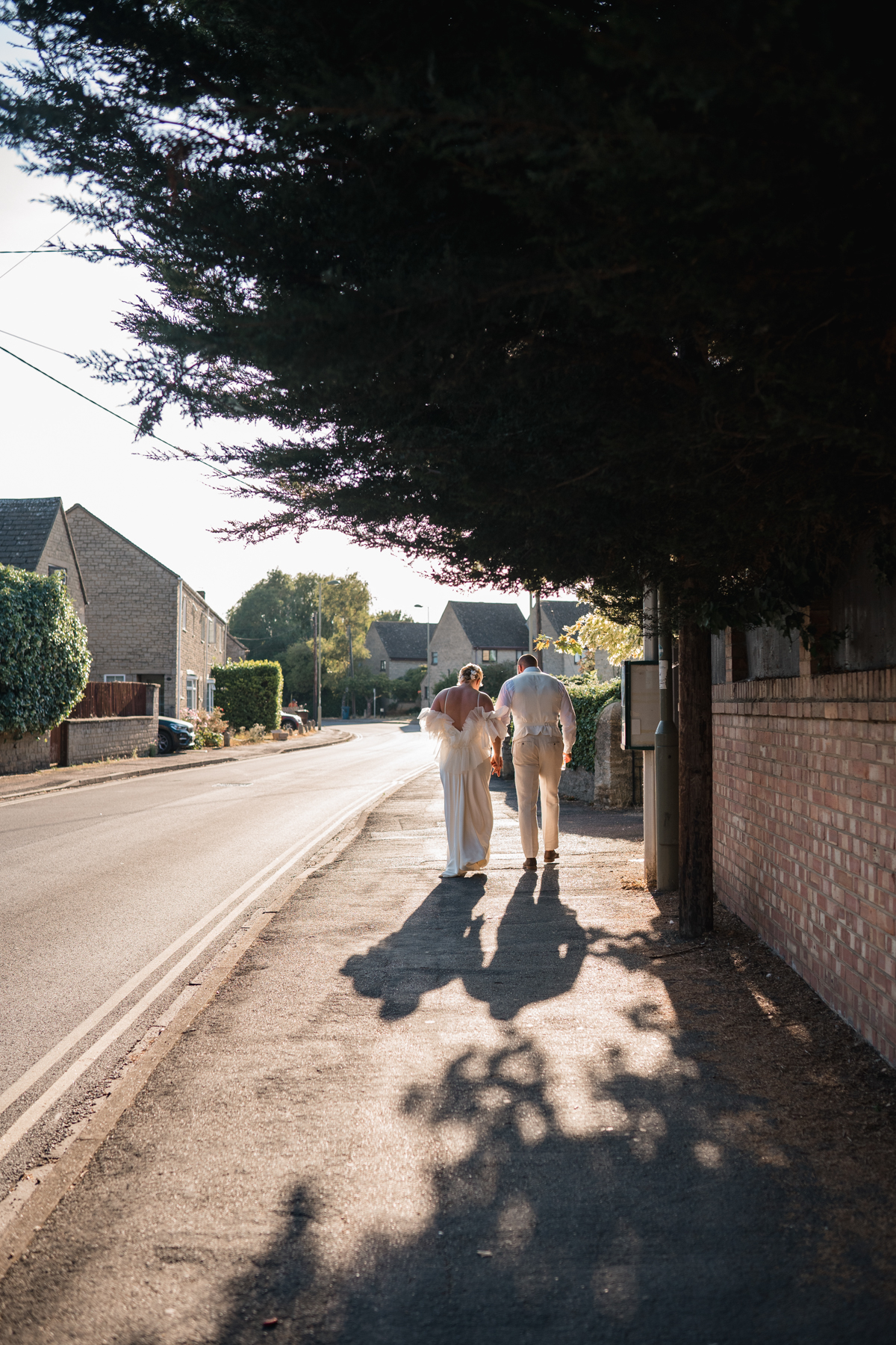bride and groom walk along oxford street
