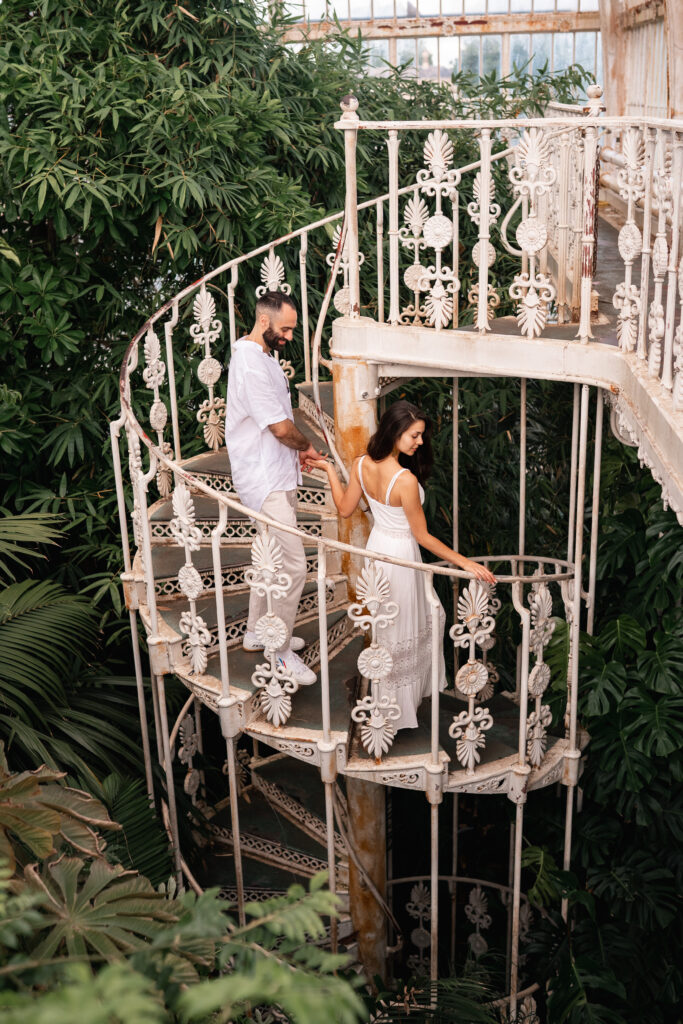 engaged couple on the spiral staircase inside KEW Gardens palm house