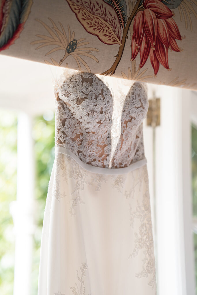 wedding dress hangs in the window at Chewton Glen