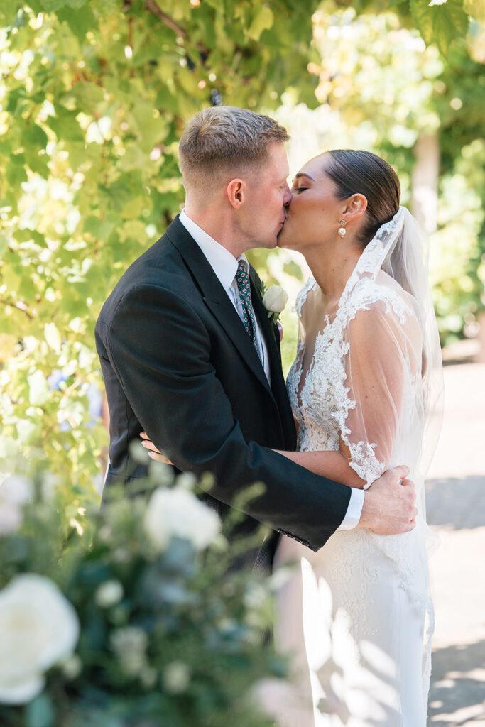 bride and groom share their first kiss at Chewton Glen wedding ceremony