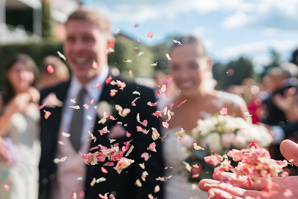 focus on Confetti with bride and groom out of focus behind