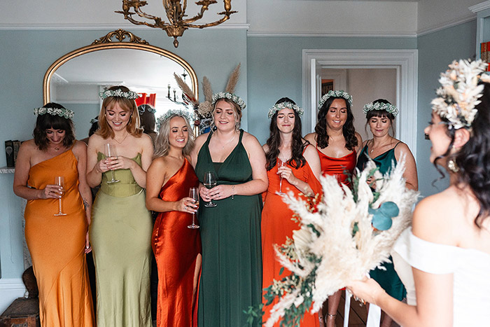 bridesmaids in jewel toned dresses on wedding morning