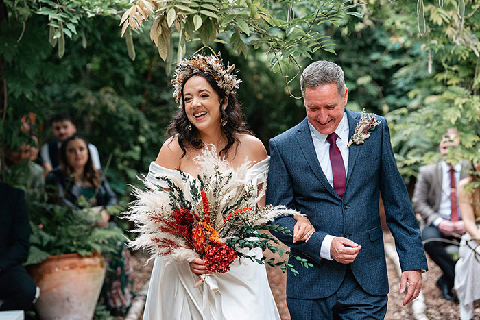 bride with dry flower bouquet and flower crown, and her father walking down the aisle at Harewood Forest