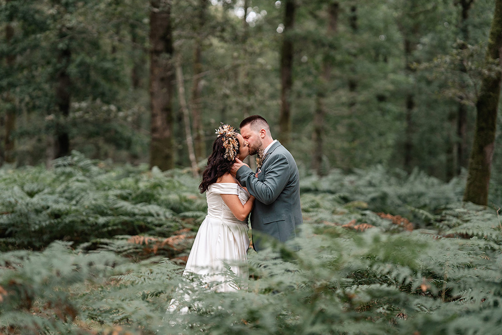 bride and groom kiss surrounded by forest at Harewood Wedding Venue