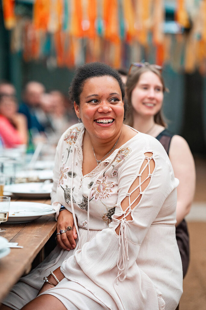 guest smiles during wedding breakfast at Harewood Forest wedding