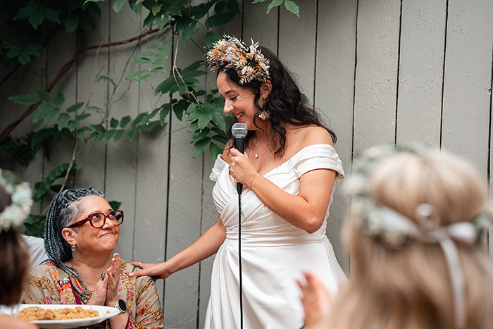bride touches mum on shoulder, both smile at each other