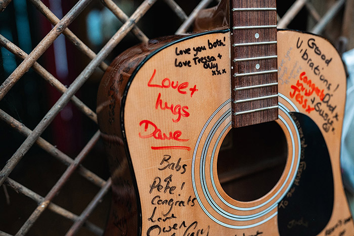 alternative guestbook idea, everyone is signing a guitar