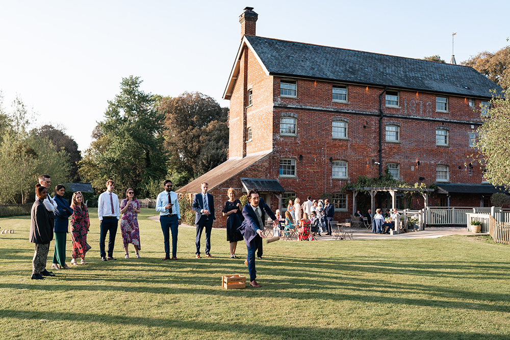 guests play lawn games at Sopley Mill wedding