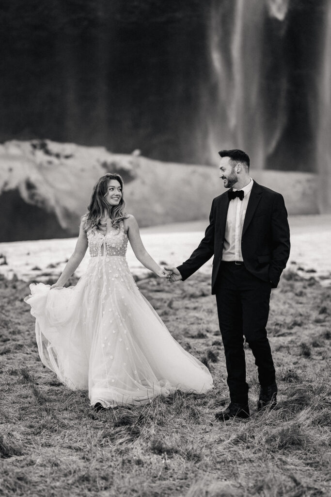 black and white portrait as bride and groom smile at each other at Iceland Elopement