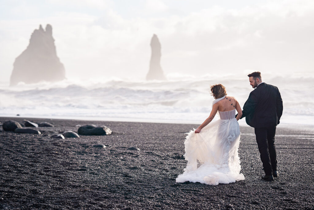 bride and groom on black sand beach in Iceland