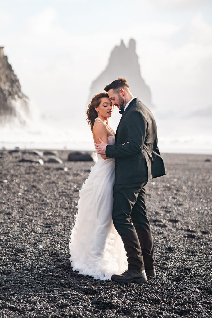 bride and groom on black sand beach in Iceland