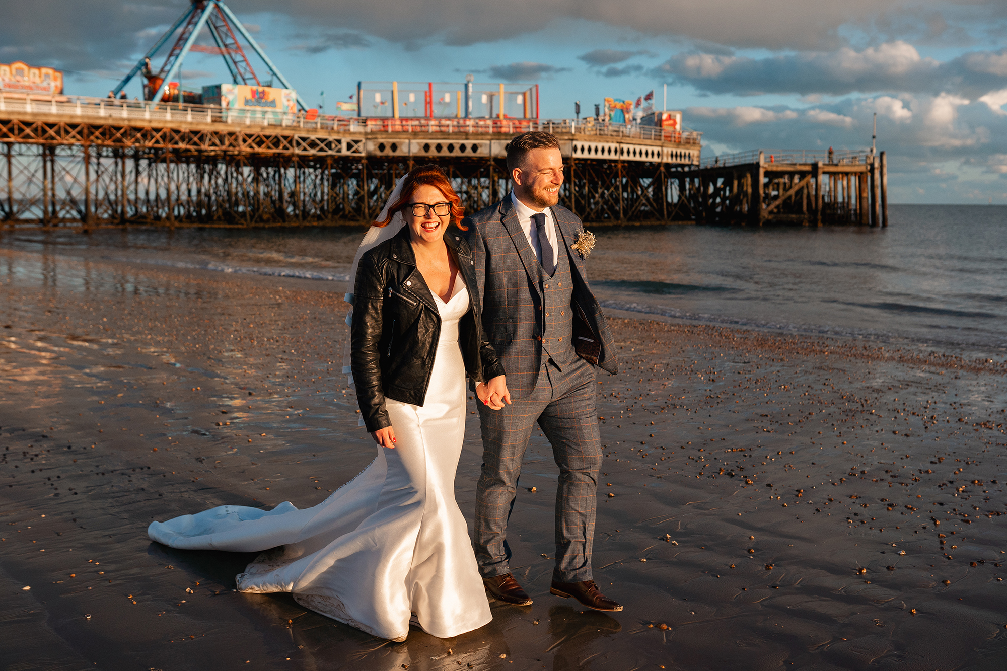 Bride and Groom walk on Southsea Beach at Sunset for their Portsmouth Wedding Photographer