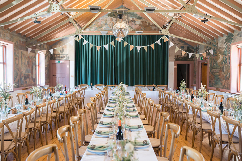 hand painted interior of village hall with wedding breakfast set up inside