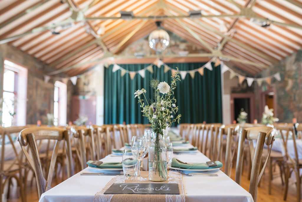 hand painted interior of village hall with wedding breakfast set up inside