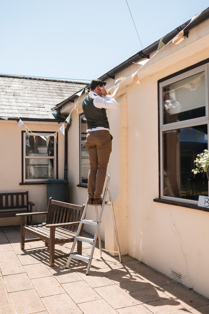 Guest helps put up decoration at eco-friendly wedding