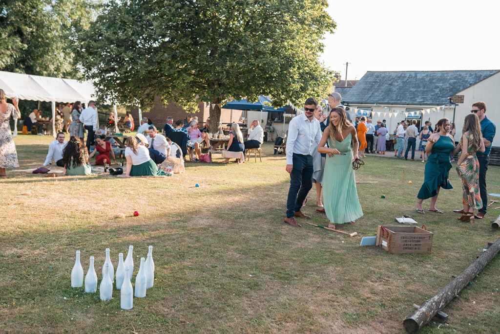 Guests at eco-friendly wedding play with handmade garden games