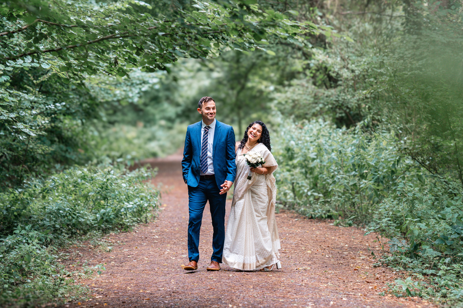 Woodland wedding where couple stand together in the trees 