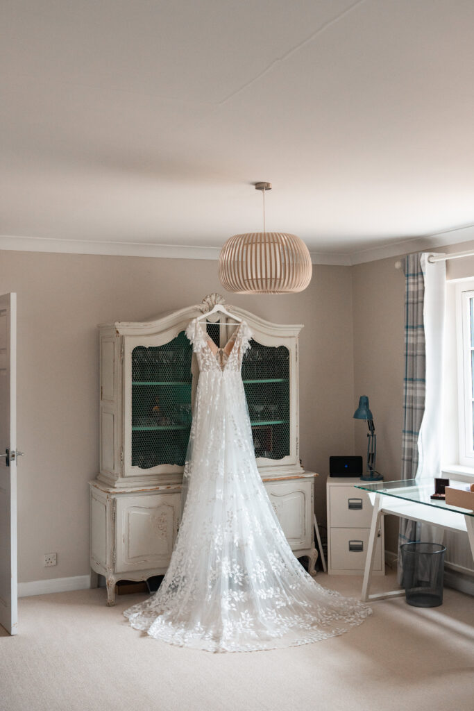 wedding dress hanging on cabinet 