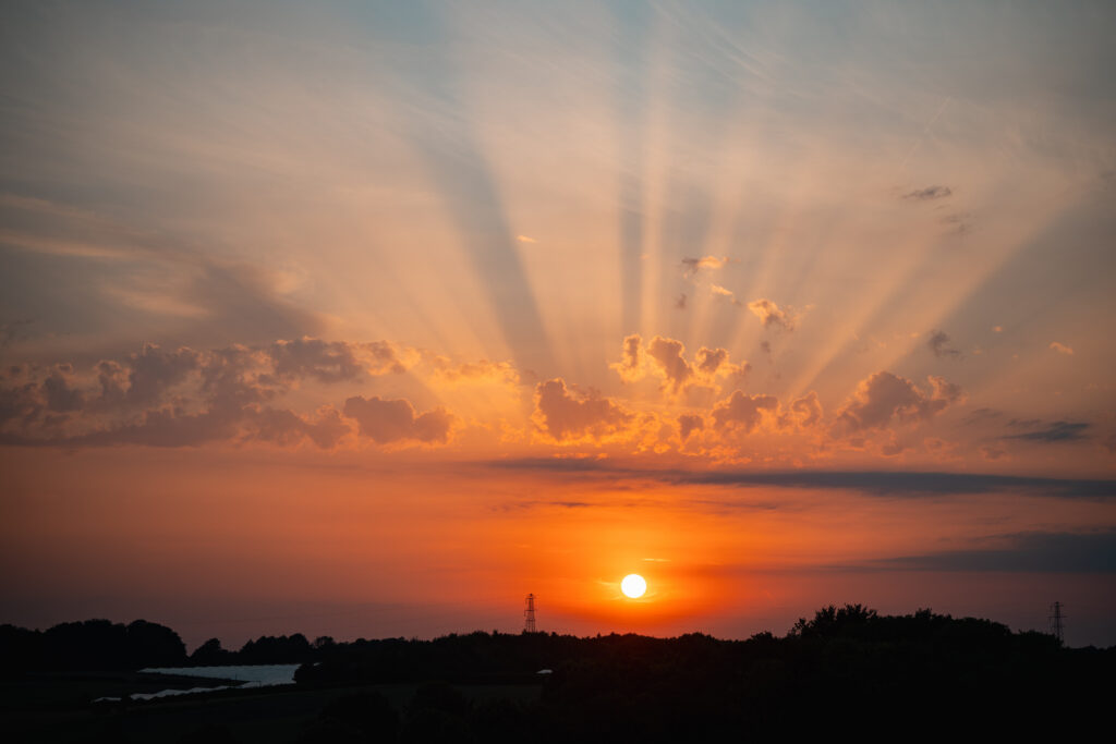 view of sunset over the fields at Harewood Forest wedding venue