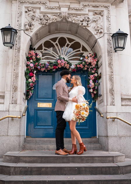 Couple kiss on Chelsea town hall steps after their London wedding