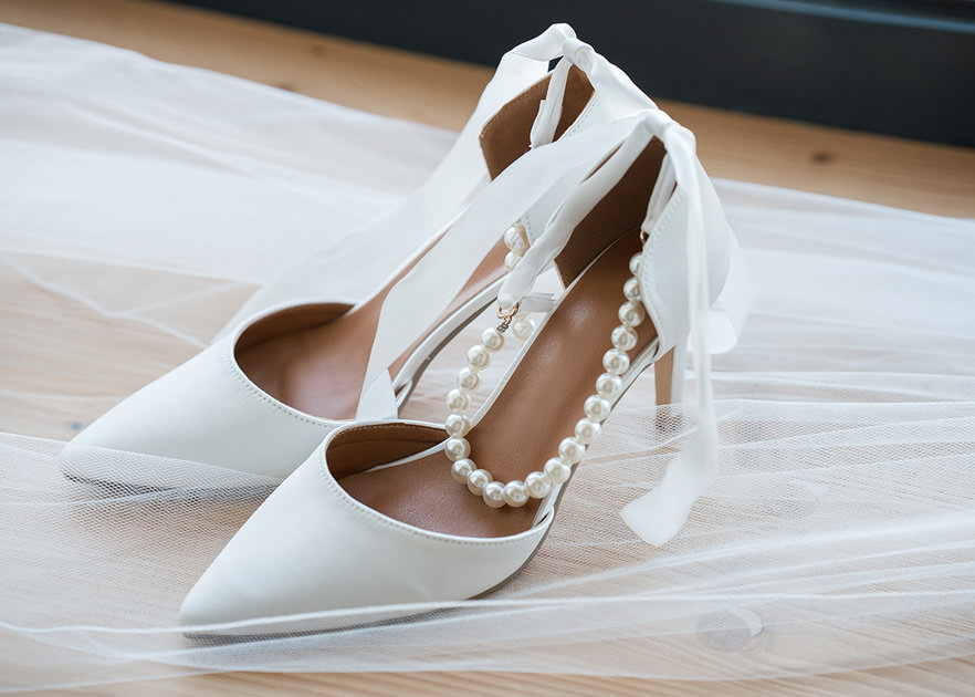 shoes with a pearl band sit on top of veil